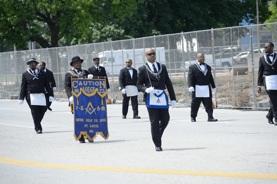 Event photography: Caution Lodge No. 23 members in black suits and aprons marching in a St. Louis parade