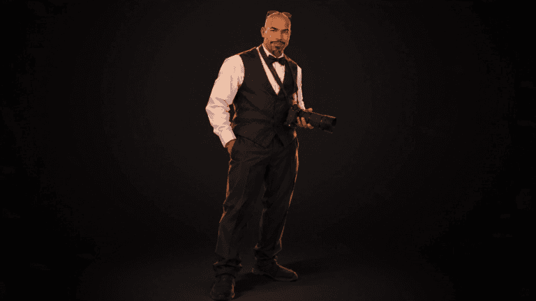 Wyatt Clark of DJ Dub Photography in a black vest and bow tie, holding his camera